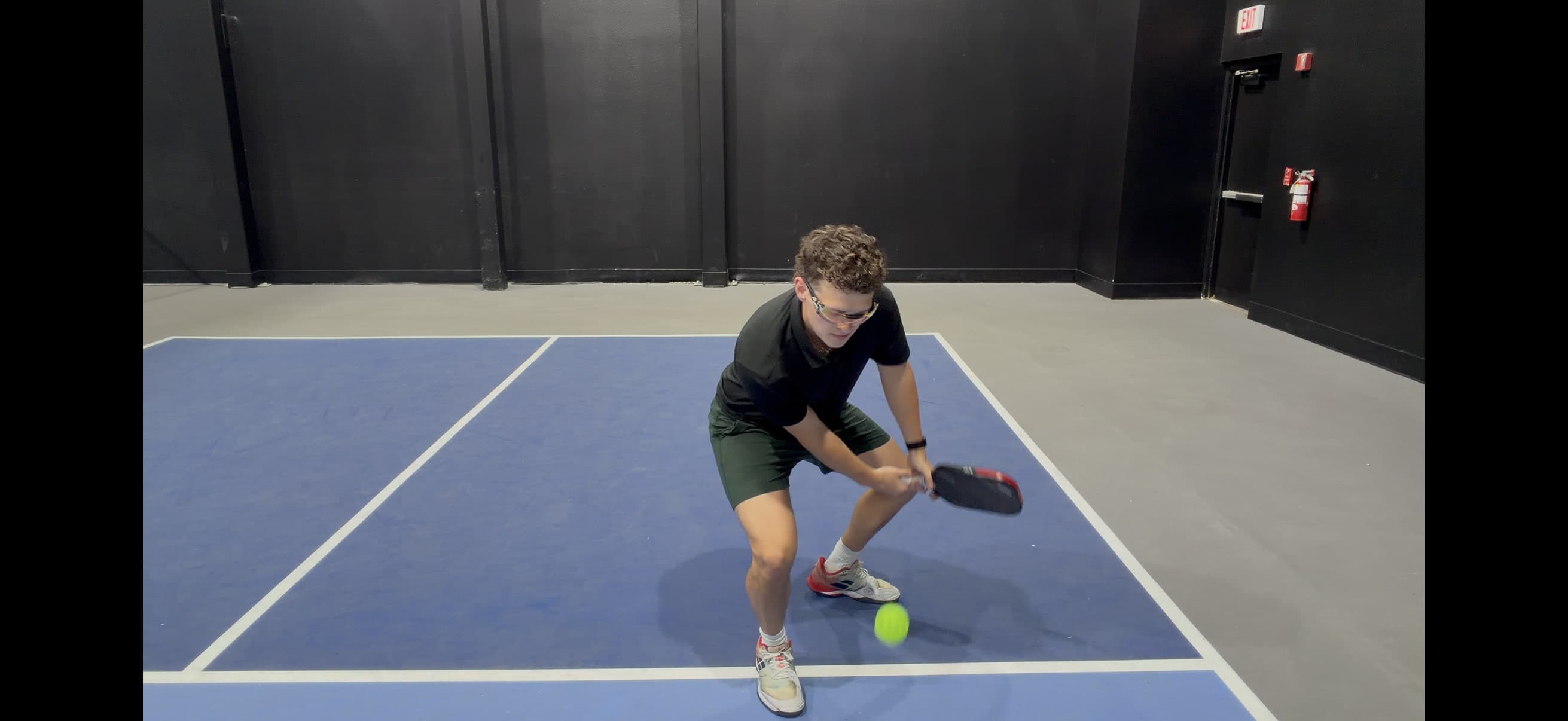 Coach Ryan McCarthy playing a low volley during a rally